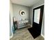 Welcoming entryway with a decorative mirror, console table, and stylish flooring near the front door at 12300 4Th E St, Treasure Island, FL 33706