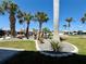 Meticulously landscaped front yard featuring mature palm trees, rock gardens, and manicured lawn for curb appeal at 12300 4Th E St, Treasure Island, FL 33706