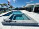 Stunning pool and spa with a decorative alligator sculpture, set against a picturesque waterfront backdrop at 12300 4Th E St, Treasure Island, FL 33706