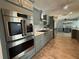 Spacious kitchen with stainless steel appliances, grey cabinets, backsplash and light countertops and floors at 12300 4Th E St, Treasure Island, FL 33706