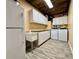 Utility room with sink, washer, and dryer, with ample overhead storage at 12300 4Th E St, Treasure Island, FL 33706
