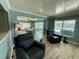 Bright living room boasts modern furniture and beautiful water views from large windows at 12300 4Th E St, Treasure Island, FL 33706
