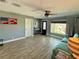 Inviting living room features a ceiling fan, front door view, and wood-look tile flooring at 12300 4Th E St, Treasure Island, FL 33706