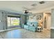 Cozy living room with a comfortable sofa, decorative pelican art, and bright natural light through the window at 12300 4Th E St, Treasure Island, FL 33706