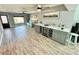Spacious living room features tile floors, a bar with wine fridge and a picture window at 12300 4Th E St, Treasure Island, FL 33706