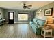 Comfortable living room featuring a sofa, stylish pelican art, and large window with backyard views at 12300 4Th E St, Treasure Island, FL 33706