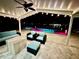 Outdoor patio with contemporary seating overlooks the pool and canal with overhead lighting at 12300 4Th E St, Treasure Island, FL 33706
