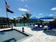Pool area with lounge chairs and umbrellas, creating a resort-style outdoor experience at 12300 4Th E St, Treasure Island, FL 33706