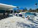 Exterior shot of the patio with pool, lounge chairs and bar, and water views at 12300 4Th E St, Treasure Island, FL 33706