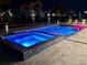 Backyard pool and spa feature color changing lights and grey-tiled walls at 12300 4Th E St, Treasure Island, FL 33706