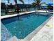 Sparkling pool surrounded by a patio and lush landscaping, perfect for outdoor relaxation at 12300 4Th E St, Treasure Island, FL 33706