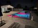 Backyard pool with spa features color changing lights with chairs and a patio nearby at 12300 4Th E St, Treasure Island, FL 33706