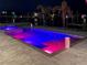 Stunning in-ground pool with integrated bar stools, paired with an attached hot tub for a luxurious outdoor experience at 12300 4Th E St, Treasure Island, FL 33706
