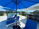 Relaxing poolside lounge area featuring plush chaise lounges and umbrellas, perfect for waterfront enjoyment at 12300 4Th E St, Treasure Island, FL 33706