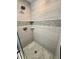 Modern shower with white subway tile, pebble accent stripe, and frameless glass enclosure at 12300 4Th E St, Treasure Island, FL 33706