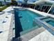 Stunning waterfront pool featuring stingray inlays, complemented by a relaxing spa and outdoor lounge area at 12300 4Th E St, Treasure Island, FL 33706