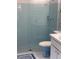 Bathroom shower with blue tile and toilet at 12801 Winding Way, Hudson, FL 34667