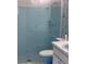 Bathroom features blue tiled walk-in shower and matching sink and toilet at 12801 Winding Way, Hudson, FL 34667