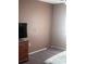 Bedroom with carpet and a television on a dresser at 12801 Winding Way, Hudson, FL 34667