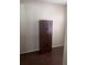 Bedroom features hardwood floors, neutral walls, and a wardrobe closet for storage at 12801 Winding Way, Hudson, FL 34667