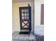 Inviting front entrance with a security gate and patterned tile flooring, creating a secure and stylish welcome at 12801 Winding Way, Hudson, FL 34667