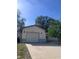 Traditional one-story home featuring an attached garage and a well-kept driveway at 12801 Winding Way, Hudson, FL 34667