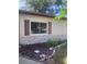 Charming ranch-style home with brick accents, dark shutters, and a manicured garden bed at 12801 Winding Way, Hudson, FL 34667