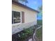 Well-maintained home exterior features brick accents and a manicured flower bed at 12801 Winding Way, Hudson, FL 34667