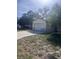 Home's garage with a paved driveway, set against a bright, sunny sky at 12801 Winding Way, Hudson, FL 34667