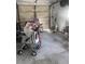 Spacious garage with concrete floor, ready for customization and storage with an open garage door at 12801 Winding Way, Hudson, FL 34667