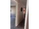 Hallway with neutral walls and carpet, connecting the home's spaces and a view to other areas at 12801 Winding Way, Hudson, FL 34667