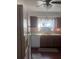 Functional kitchen features wooden cabinets, white appliances, double basin sink and a window for natural light at 12801 Winding Way, Hudson, FL 34667