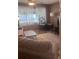 Carpeted living room featuring a window with curtains and a ceiling fan with light at 12801 Winding Way, Hudson, FL 34667