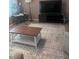 Cozy living room featuring a patterned rug, coffee table, and modern media center at 12801 Winding Way, Hudson, FL 34667