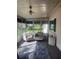 Relaxing enclosed patio featuring neutral furniture and a ceiling fan for a comfortable outdoor experience at 12801 Winding Way, Hudson, FL 34667