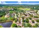 Idyllic aerial view shows a home close to a scenic golf course and lush green trees at 12910 Leadwood Dr, Riverview, FL 33579