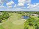 Aerial view of the community golf course, surrounded by ponds and lush landscaping at 12910 Leadwood Dr, Riverview, FL 33579