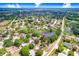 Aerial view of the neighborhood showcasing a scenic pond and community at 12910 Leadwood Dr, Riverview, FL 33579