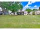 Spacious backyard with mature trees and lush green lawn at 12910 Leadwood Dr, Riverview, FL 33579