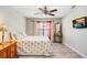 Cozy bedroom with wood floors, a ceiling fan, and a window at 12910 Leadwood Dr, Riverview, FL 33579