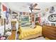 Charming bedroom with colorful decorations, a vintage bed frame, and view of the lake at 12910 Leadwood Dr, Riverview, FL 33579
