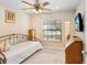Neutral bedroom with a simple bed frame, wood dresser, and ample natural light at 12910 Leadwood Dr, Riverview, FL 33579