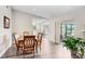 Light-filled dining room featuring wood floors and elegant furniture, seamlessly flowing into other living spaces at 12910 Leadwood Dr, Riverview, FL 33579