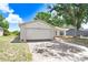 Charming single-story home with a well-maintained lawn, mature tree, and an attached two-car garage at 12910 Leadwood Dr, Riverview, FL 33579