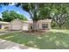 Charming single-story home with a well-maintained lawn, mature tree, and an attached two-car garage at 12910 Leadwood Dr, Riverview, FL 33579