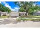 Charming single-story home with a well-maintained lawn, mature tree, and an attached two-car garage at 12910 Leadwood Dr, Riverview, FL 33579
