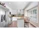 Bright kitchen with white cabinets, stainless steel appliances, and a cozy breakfast bar at 12910 Leadwood Dr, Riverview, FL 33579