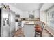 Bright kitchen with white cabinets, stainless steel appliances, and a cozy breakfast bar at 12910 Leadwood Dr, Riverview, FL 33579