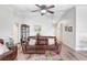 Cozy living room with a leather sofa, wood-look floors, and neutral wall color creating a relaxing ambiance at 12910 Leadwood Dr, Riverview, FL 33579