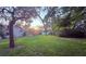 Expansive backyard featuring mature trees and a glimpse of the pool area at 13133 Roseanna Dr, Spring Hill, FL 34609
